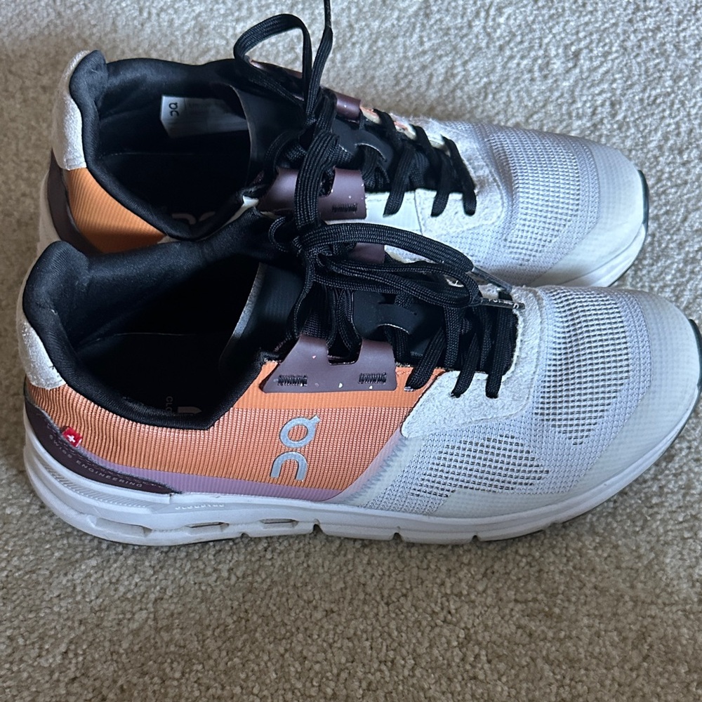 On Running White and Orange Athletic Shoes